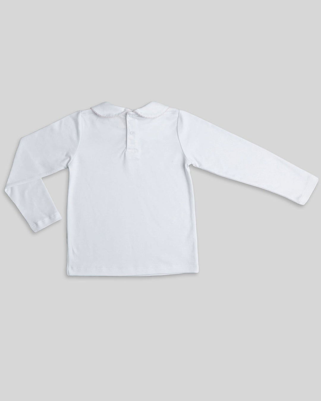 Polo blanco con picoeta rosada para niñas, detalle sutil y encantador para un estilo tierno.
